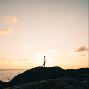 Person Standing on Rock Mountain Fronting the Sea